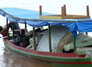 Enchente destrói pontes e lavrador precisa usar barco como caminhão de mudanças para retirar pertences de casa