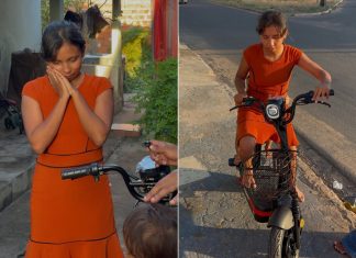 Mãe que levava filho de 2 anos para escola amarrado à cintura ganha bicicleta elétrica no TO; VÍDEO